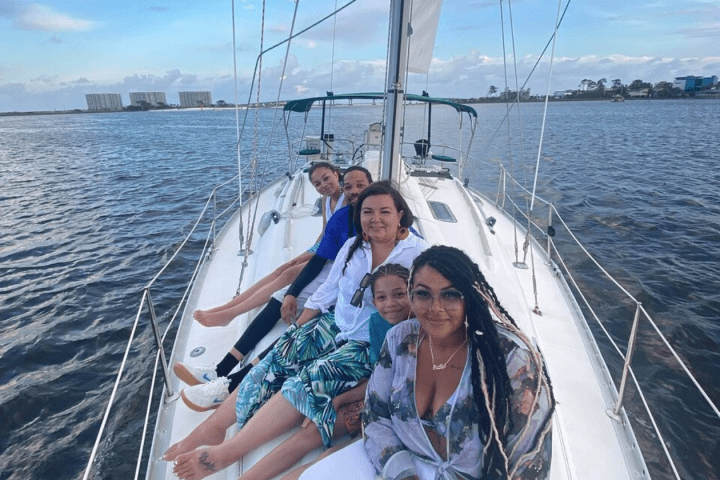 a person standing in front of a boat next to a body of water