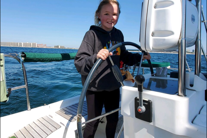 a person riding on the back of a boat